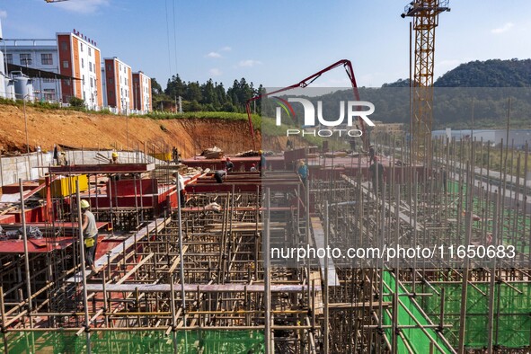 Workers work at the construction site of the 2024 help workshop in Congjiang County, Guizhou Province, China, on October 8, 2024. 