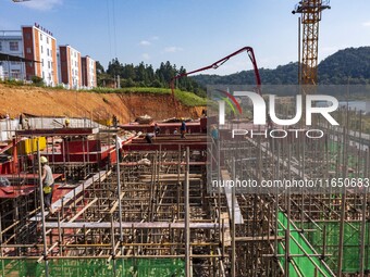 Workers work at the construction site of the 2024 help workshop in Congjiang County, Guizhou Province, China, on October 8, 2024. (