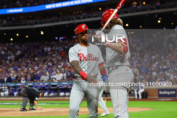 Edmundo Sosa #33 of the Philadelphia Phillies heads towards the dugout after scoring during the eighth inning in Game 3 of a baseball NL Div...