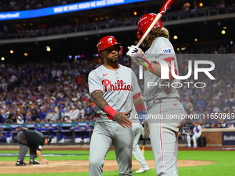 Edmundo Sosa #33 of the Philadelphia Phillies heads towards the dugout after scoring during the eighth inning in Game 3 of a baseball NL Div...