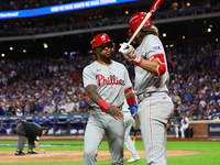 Edmundo Sosa #33 of the Philadelphia Phillies heads towards the dugout after scoring during the eighth inning in Game 3 of a baseball NL Div...