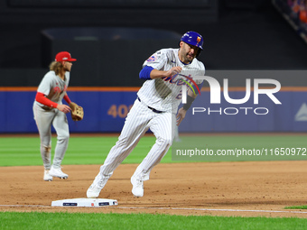 J.D. Martinez #28 of the New York Mets scores during the eighth inning in Game 3 of a baseball NL Division Series against the Philadelphia P...