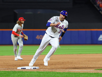 J.D. Martinez #28 of the New York Mets scores during the eighth inning in Game 3 of a baseball NL Division Series against the Philadelphia P...