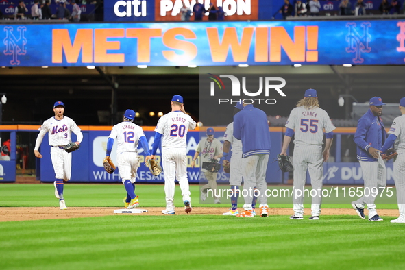 The New York Mets celebrate after their 7-2 win in Game 3 of a baseball NL Division Series against the Philadelphia Phillies at Citi Field i...