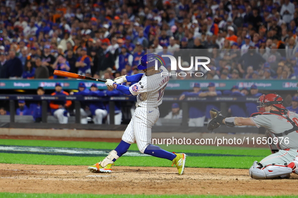 Francisco Lindor #12 of the New York Mets doubles during the eighth inning in Game 3 of a baseball NL Division Series against the Philadelph...