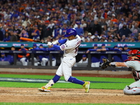 Francisco Lindor #12 of the New York Mets doubles during the eighth inning in Game 3 of a baseball NL Division Series against the Philadelph...