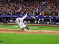 Brandon Nimmo #9 of the New York Mets scores during the seventh inning in Game 3 of a baseball NL Division Series against the Philadelphia P...