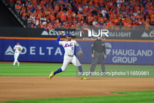 New York Mets shortstop Francisco Lindor #12 fields and throws during the seventh inning in Game 3 of a baseball NL Division Series against...