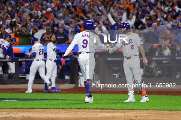 Brandon Nimmo #9 of the New York Mets is congratulated by teammate Tyrone Taylor #15 during the sixth inning in Game 3 of a baseball NL Divi...