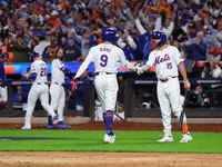 Brandon Nimmo #9 of the New York Mets is congratulated by teammate Tyrone Taylor #15 during the sixth inning in Game 3 of a baseball NL Divi...