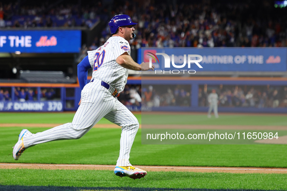 Pete Alonso #20 of the New York Mets scores during the sixth inning in Game 3 of a baseball NL Division Series against the Philadelphia Phil...