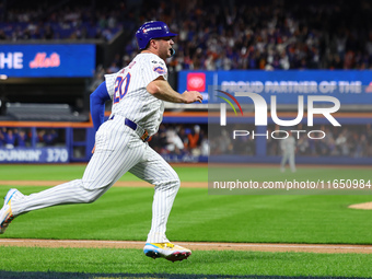 Pete Alonso #20 of the New York Mets scores during the sixth inning in Game 3 of a baseball NL Division Series against the Philadelphia Phil...