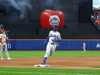 Jesse Winker #3 of the New York Mets rounds the bases after hitting a solo home run during the fourth inning in Game 3 of a baseball NL Divi...