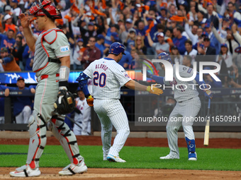 Pete Alonso #20 of the New York Mets rounds the bases after homering during the second inning in Game 3 of a baseball NL Division Series aga...