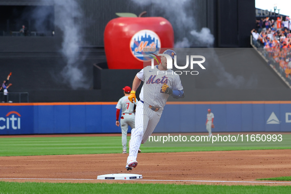 Pete Alonso #20 of the New York Mets rounds the bases after homering during the second inning in Game 3 of a baseball NL Division Series aga...