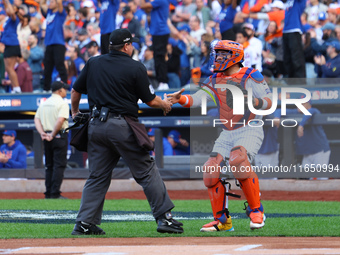 New York Mets catcher Francisco Alvarez #4 shakes hands with home plate umpire Doug Eddings during the first inning in Game 3 of a baseball...