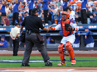 New York Mets catcher Francisco Alvarez #4 shakes hands with home plate umpire Doug Eddings during the first inning in Game 3 of a baseball...