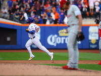 Pete Alonso #20 of the New York Mets rounds the bases after homering as Philadelphia Phillies starting pitcher Aaron Nola #27 stands on the...