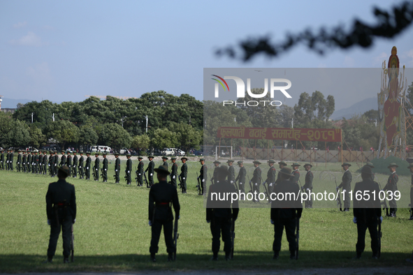 Nepal Army personnel stand in line preparing for the grand rehearsal of the Phulpati celebration at the army pavilion in Kathmandu, Nepal, o...