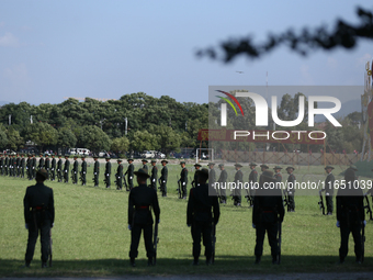 Nepal Army personnel stand in line preparing for the grand rehearsal of the Phulpati celebration at the army pavilion in Kathmandu, Nepal, o...