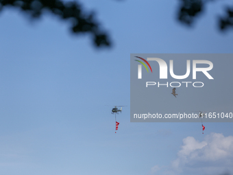 An eagle takes flight as a Nepal Army helicopter hoists the banner with wishes of Phulpati during the grand rehearsal in Nepal on October 8,...