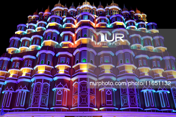 Visitors look at a makeshift place of worship made as a replica of the Hawa Mahal Palace during the Durga Puja festival celebration in Kolka...