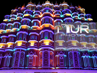 Visitors look at a makeshift place of worship made as a replica of the Hawa Mahal Palace during the Durga Puja festival celebration in Kolka...