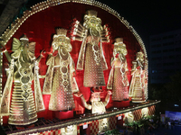 People gather at this 100-foot Hindu goddess Durga puja pandal, a temporary structure set up during the Durga Puja festival, near Kolkata, I...