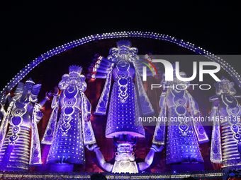 People gather at this 100-foot Hindu goddess Durga puja pandal, a temporary structure set up during the Durga Puja festival, near Kolkata, I...