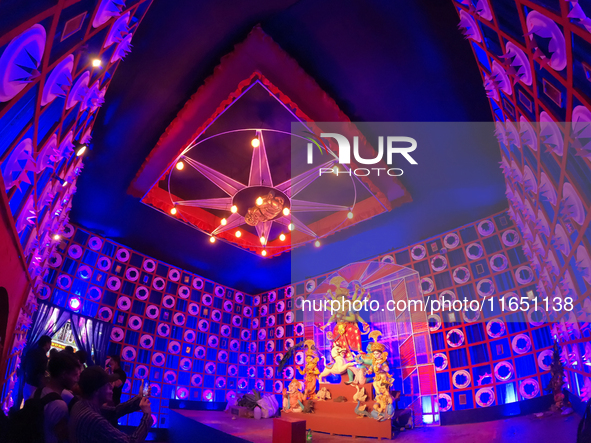 A Hindu Goddess Durga idol is inside the decoration of a puja pandal, a temporary structure set up during the Durga Puja festival in Kolkata...