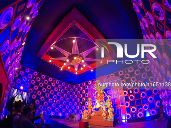 A Hindu Goddess Durga idol is inside the decoration of a puja pandal, a temporary structure set up during the Durga Puja festival in Kolkata...