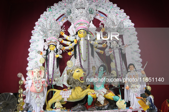 A Hindu Goddess Durga idol is inside the decoration of a puja pandal, a temporary structure set up during the Durga Puja festival in Kolkata...