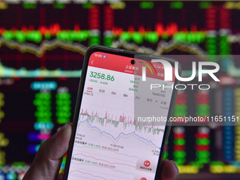 The day's stock index closing point displays on the mobile phone of a citizen in Fuyang, China, on October 9, 2024. (