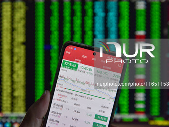 The day's stock index closing point displays on the mobile phone of a citizen in Fuyang, China, on October 9, 2024. (