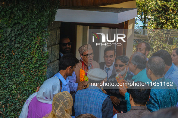 Jammu and Kashmir National Conference (JKNC) party leader Omar Abdullah (C) is greeted by supporters with garlands at his residence in Srina...