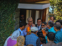 Jammu and Kashmir National Conference (JKNC) party leader Omar Abdullah (C) is greeted by supporters with garlands at his residence in Srina...