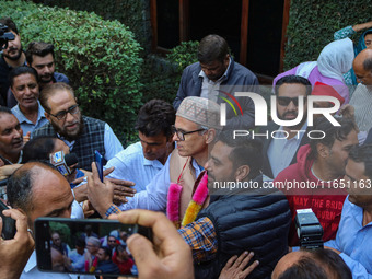 Jammu and Kashmir National Conference (JKNC) party leader Omar Abdullah (C) is greeted by supporters with garlands at his residence in Srina...