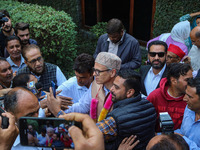 Jammu and Kashmir National Conference (JKNC) party leader Omar Abdullah (C) is greeted by supporters with garlands at his residence in Srina...