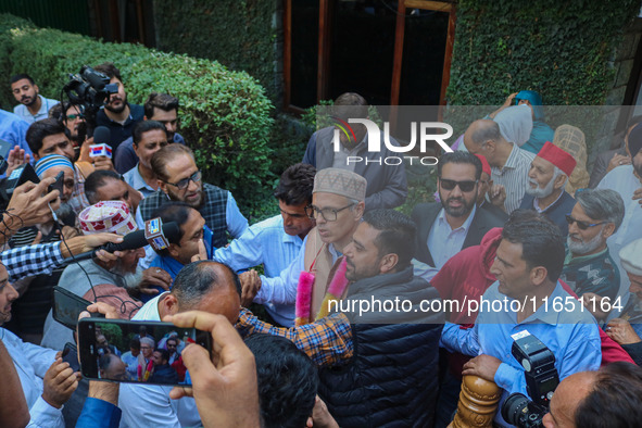 Jammu and Kashmir National Conference (JKNC) party leader Omar Abdullah (C) is greeted by supporters with garlands at his residence in Srina...