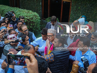 Jammu and Kashmir National Conference (JKNC) party leader Omar Abdullah (C) is greeted by supporters with garlands at his residence in Srina...