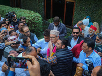 Jammu and Kashmir National Conference (JKNC) party leader Omar Abdullah (C) is greeted by supporters with garlands at his residence in Srina...