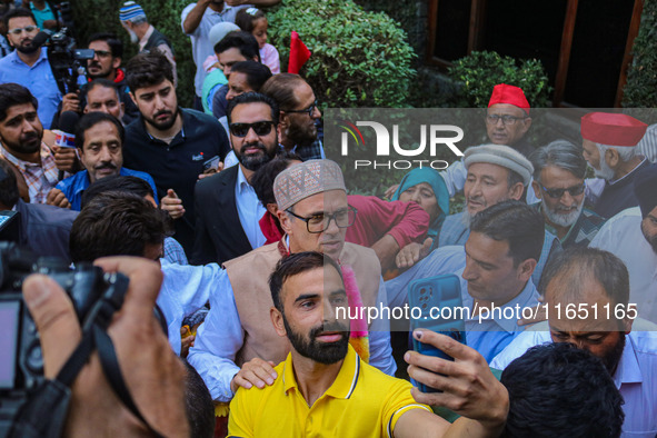 Jammu and Kashmir National Conference (JKNC) party leader Omar Abdullah (C) is greeted by supporters with garlands at his residence in Srina...