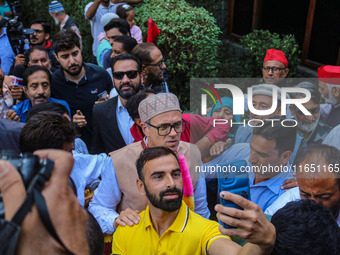 Jammu and Kashmir National Conference (JKNC) party leader Omar Abdullah (C) is greeted by supporters with garlands at his residence in Srina...