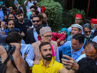 Jammu and Kashmir National Conference (JKNC) party leader Omar Abdullah (C) is greeted by supporters with garlands at his residence in Srina...