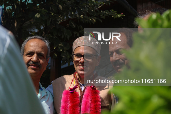 Jammu and Kashmir National Conference (JKNC) party leader Omar Abdullah (C) is greeted by supporters with garlands at his residence in Srina...