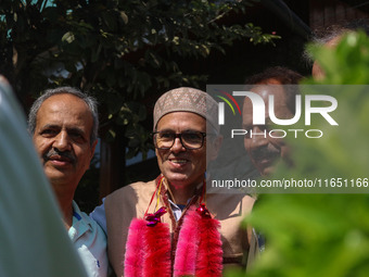 Jammu and Kashmir National Conference (JKNC) party leader Omar Abdullah (C) is greeted by supporters with garlands at his residence in Srina...