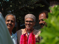 Jammu and Kashmir National Conference (JKNC) party leader Omar Abdullah (C) is greeted by supporters with garlands at his residence in Srina...