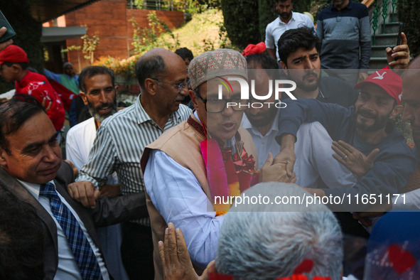 Jammu and Kashmir National Conference (JKNC) party leader Omar Abdullah (C) is greeted by supporters with garlands at his residence in Srina...