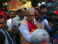 Jammu and Kashmir National Conference (JKNC) party leader Omar Abdullah (C) is greeted by supporters with garlands at his residence in Srina...