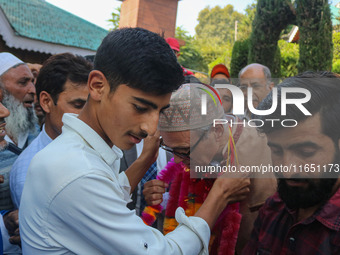 Jammu and Kashmir National Conference (JKNC) party leader Omar Abdullah (C) is greeted by supporters with garlands at his residence in Srina...